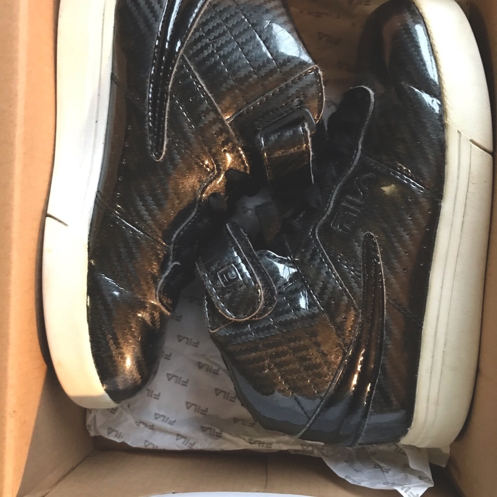 Black Fila high tops... in new condition...patent leather with white soles...